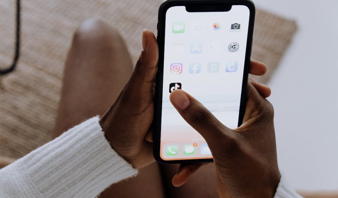 clicking the TikTok app on an iPhone
