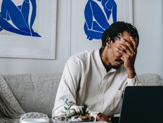 man holding his face