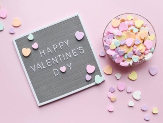 Heart shape candy and Valentine’s Day sign