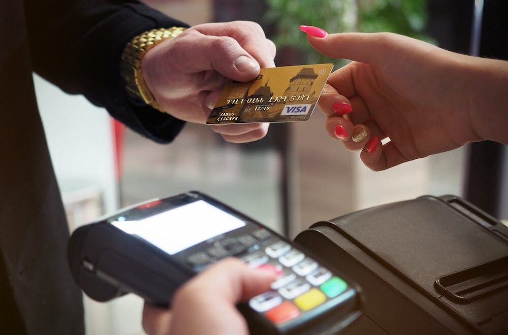 a man handing out a credit card
