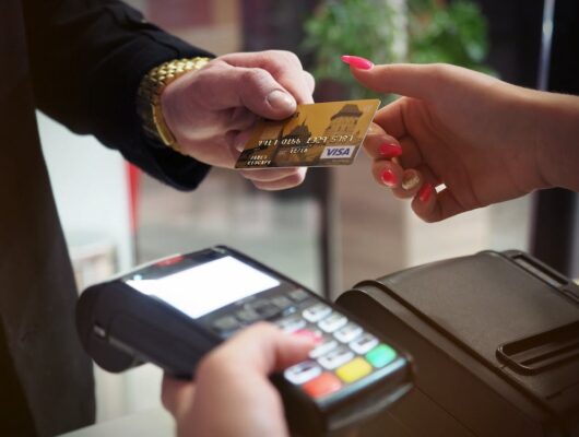 a man handing out a credit card
