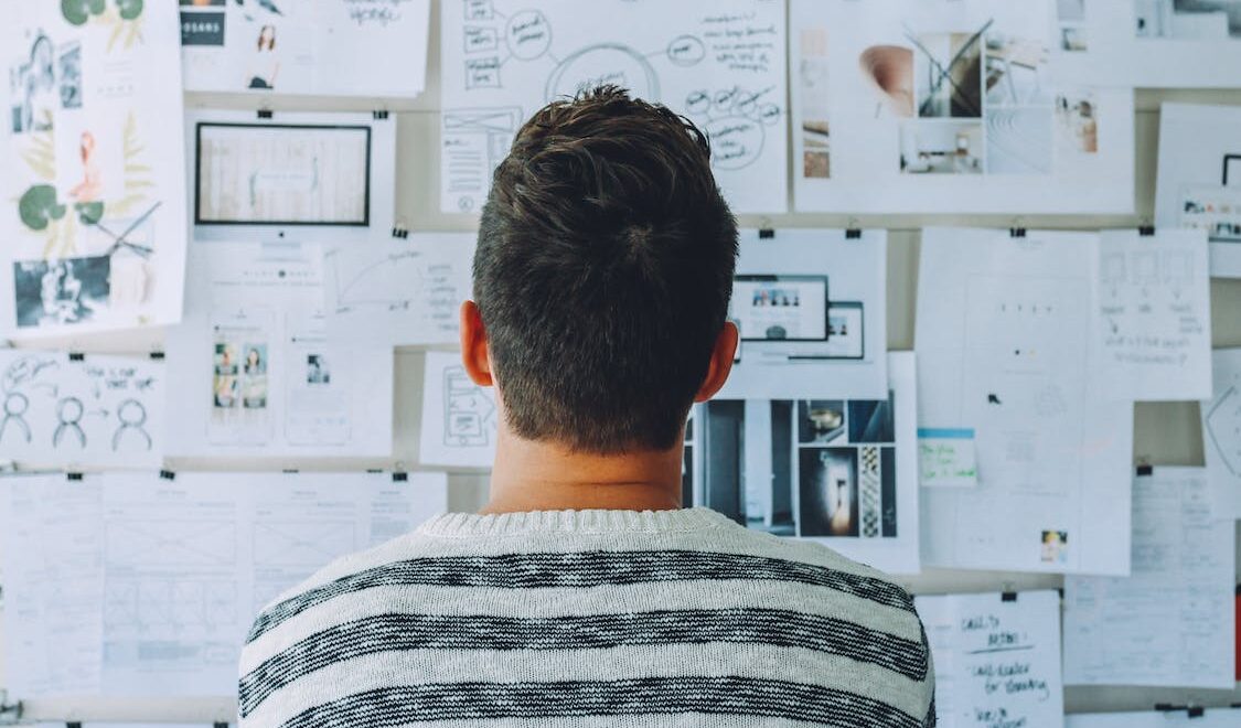 man looking at a board