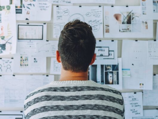 man looking at a board